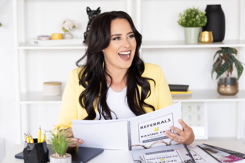 Megan Wyrick, co-founder of The Wyrick Outlook, reviewing a document at her desk