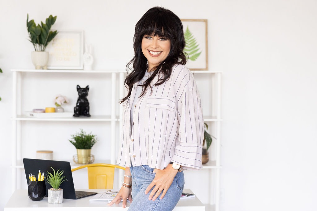 B Wyrick of The Wyrick Outlook at her studio desk